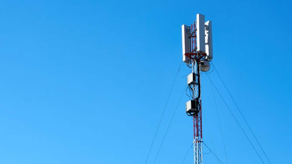 black and white electric post under blue sky during daytime