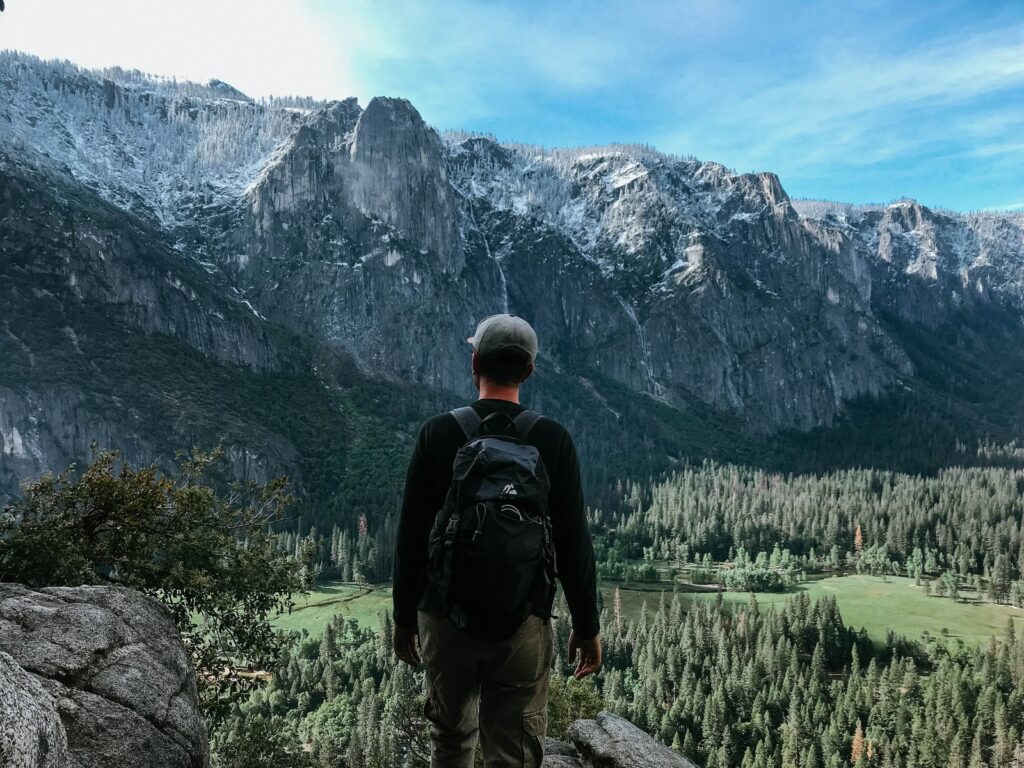 man standing on rock mountain